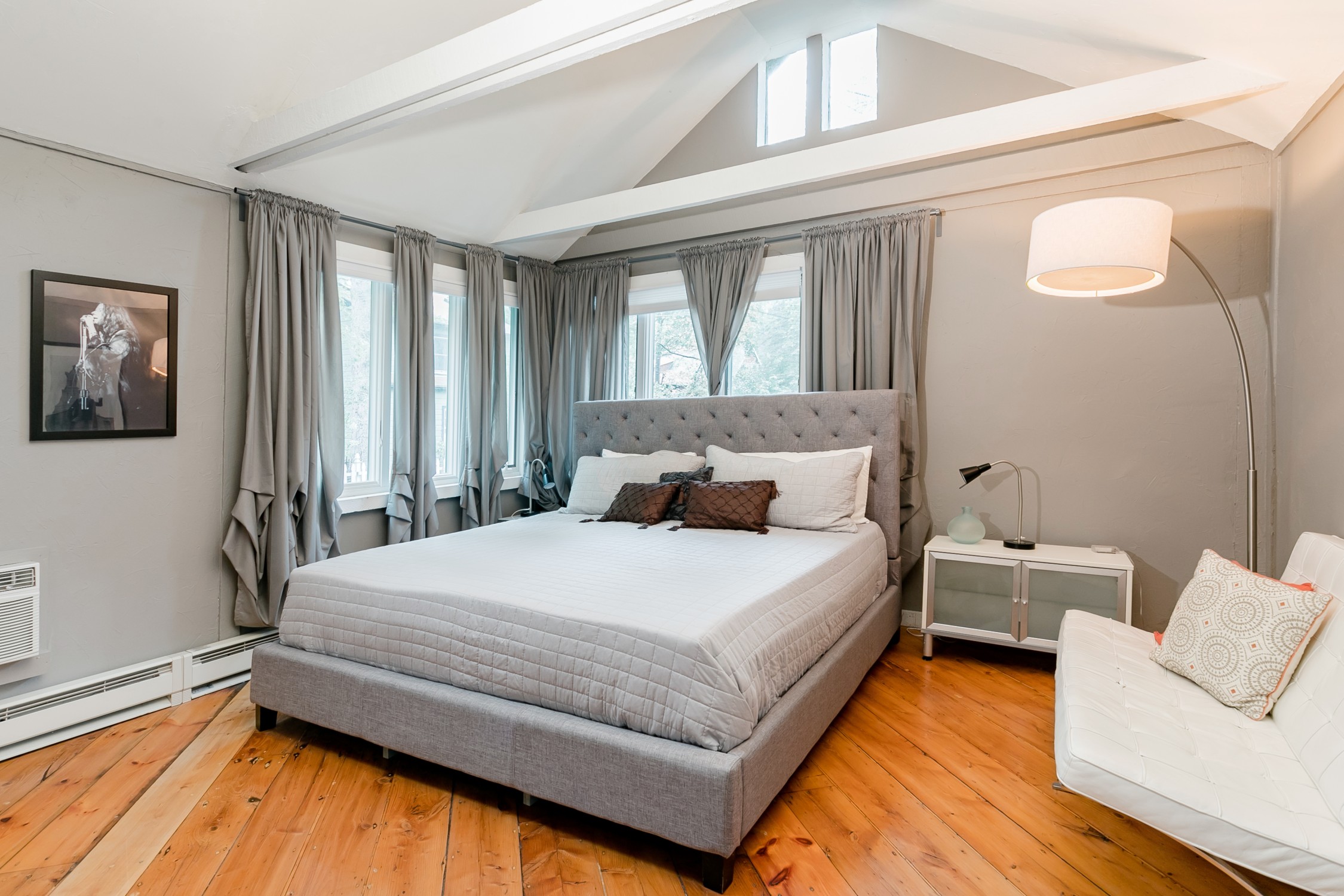 Bedroom at Sled Hill Suite 1 with whitewashed beams and natural light